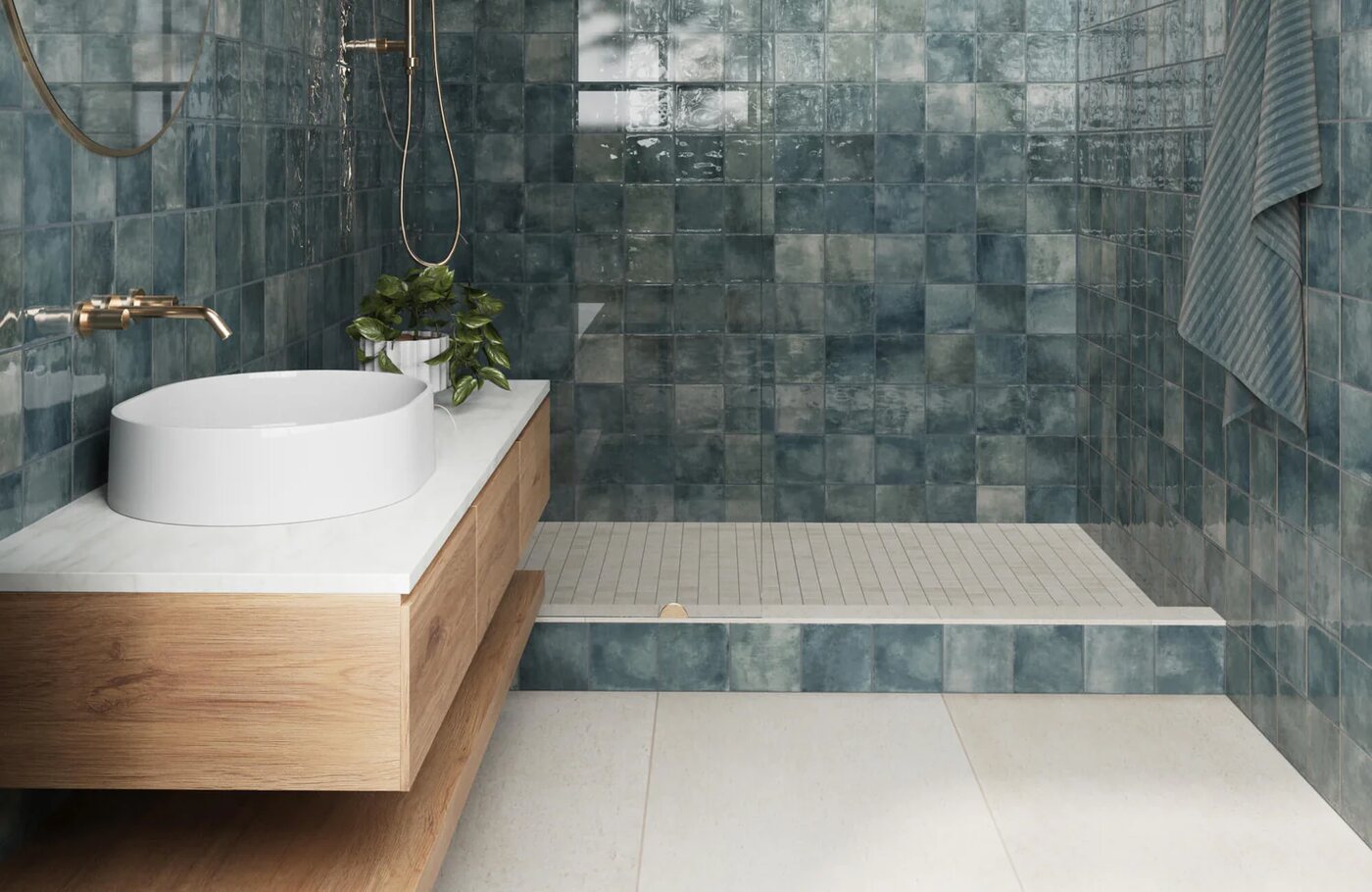 Blue tiled shower with basin and brass plumbing fixtures